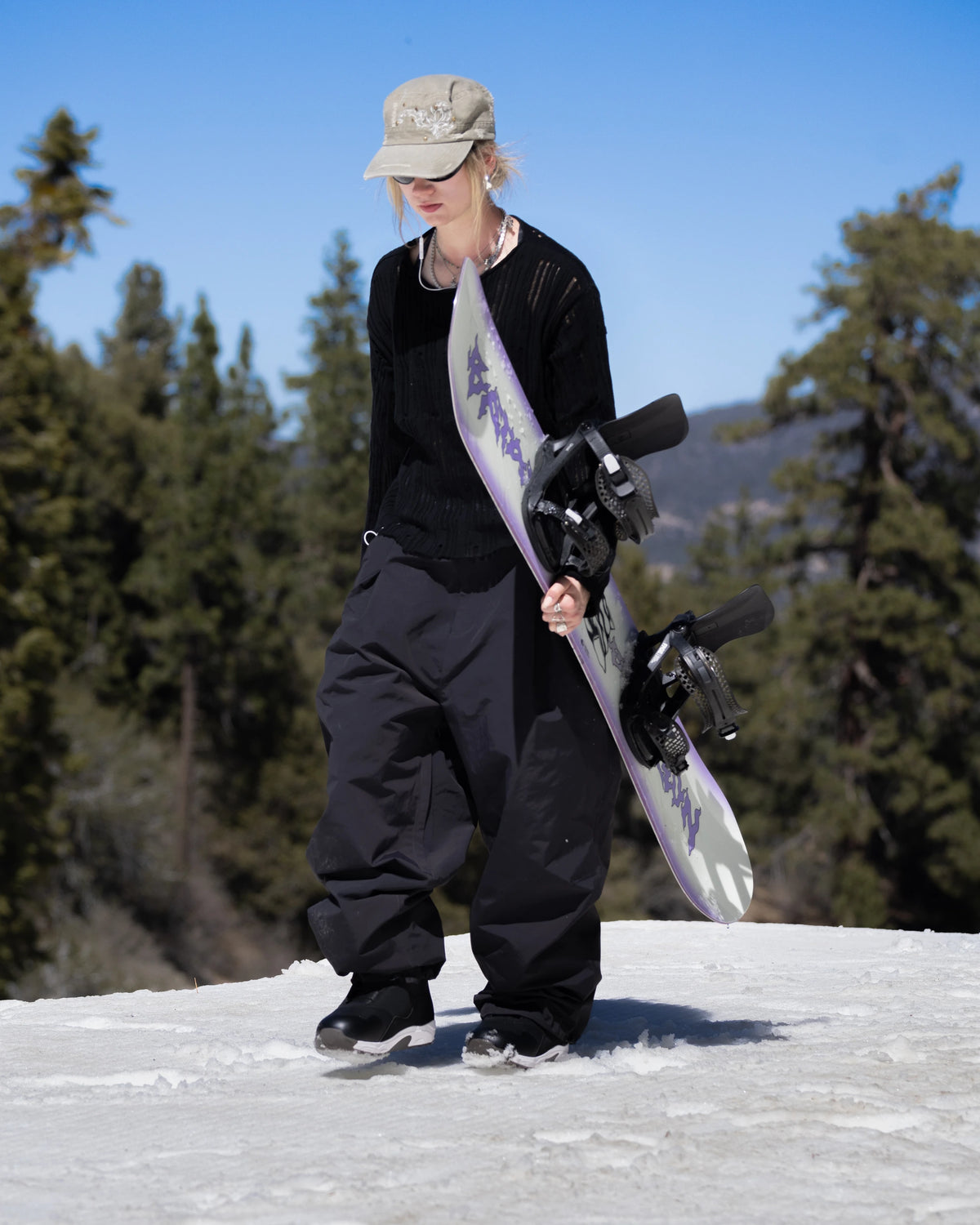 Bataleon Women's Disaster snowboard in a lifestyle shot, showcasing its design and shape for winter snowboarding.