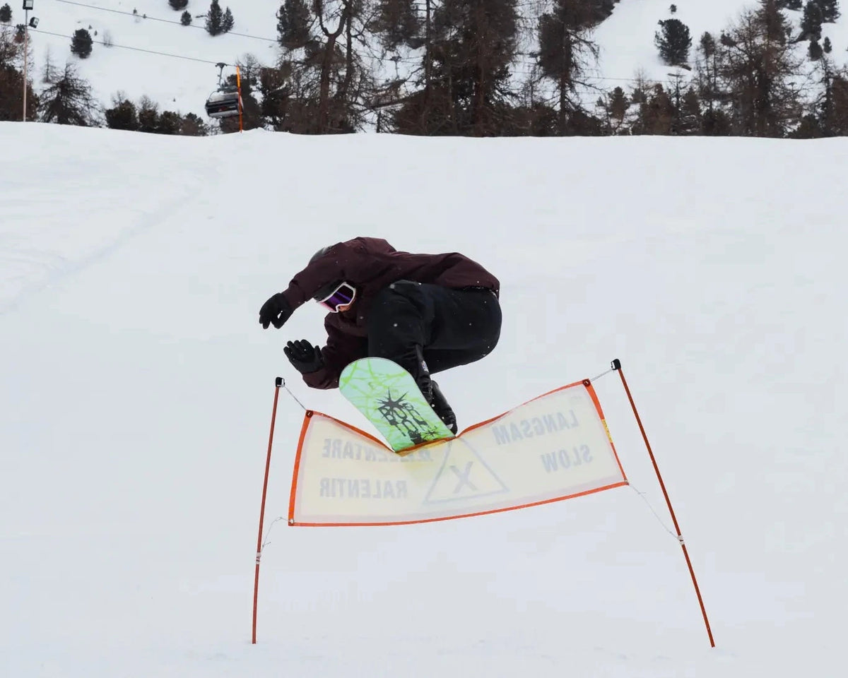 2027 Burton Process Bad Dog snowboard for men, showing the snowboard with a playful graphic design and lifestyle setting.
