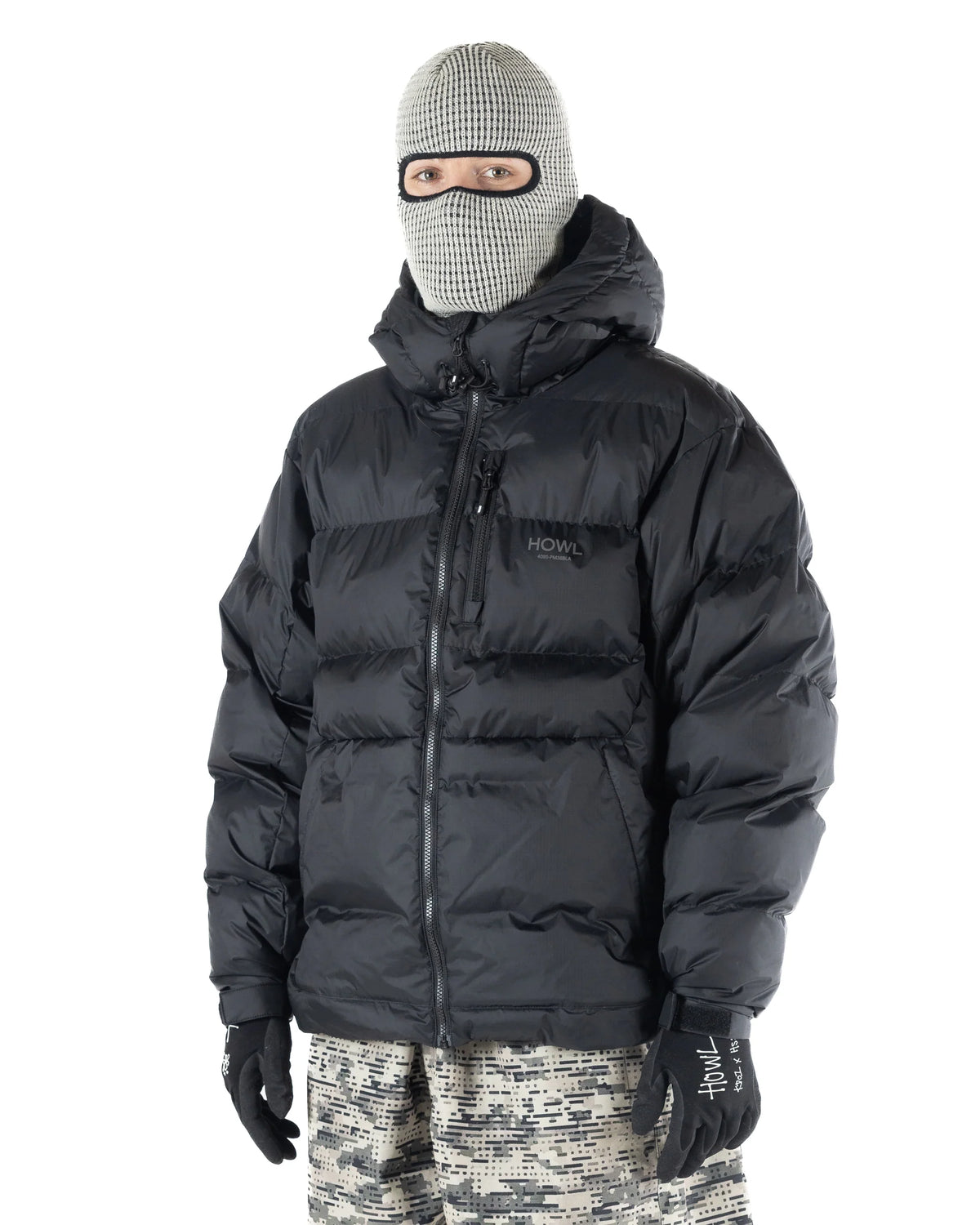 Men's black Howl Supply puffy jacket with a front view, showcasing its quilted design and insulated softgoods for cold weather wear.