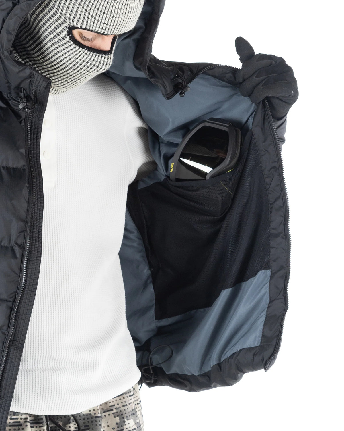 Black Howl Supply puffy men's snow jacket with a hood and goggle pocket, designed for warmth and outdoor winter activities.