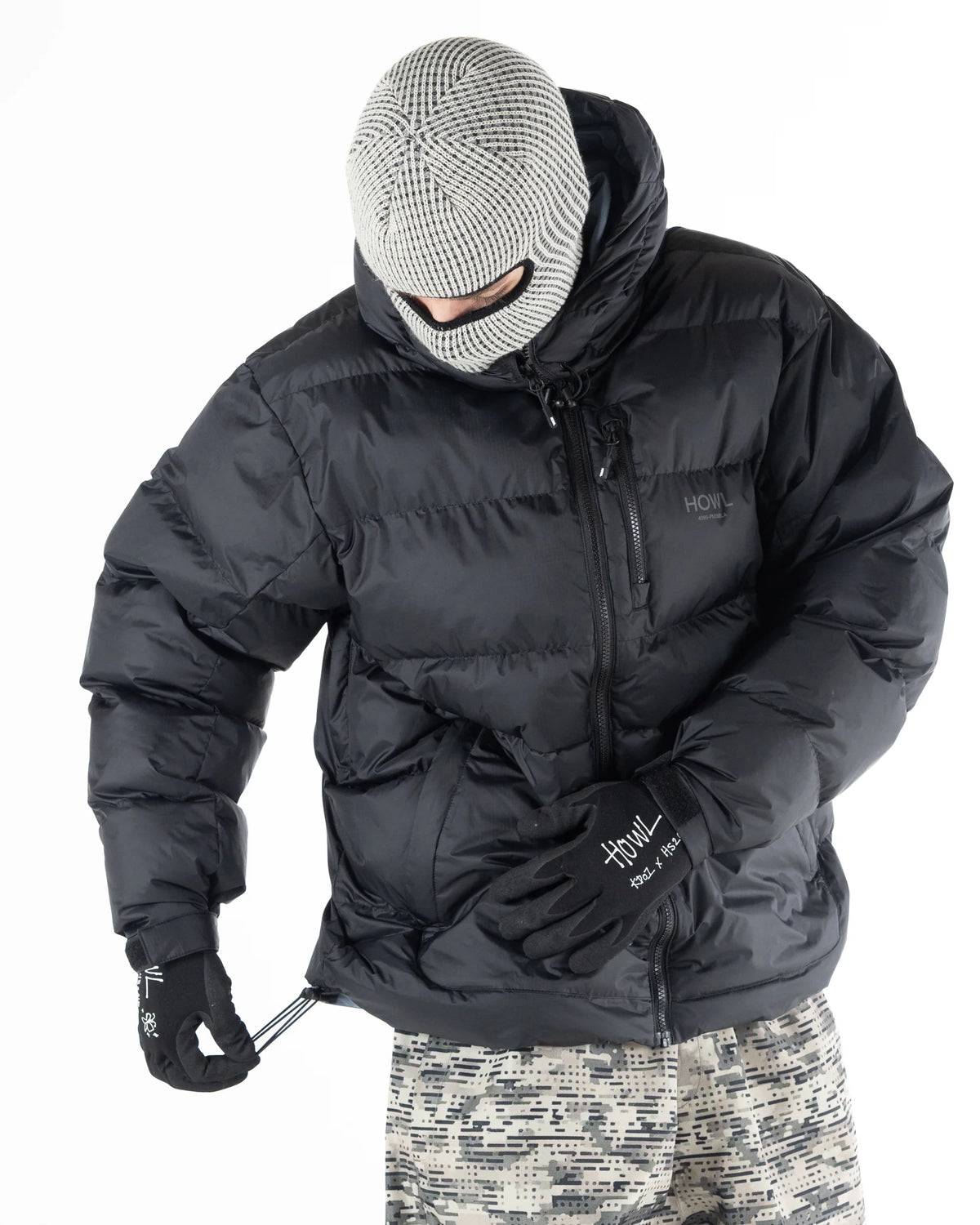 Black Howl Supply puffy men's snow jacket with waist cinch, insulated softgoods for cold weather outdoor wear.