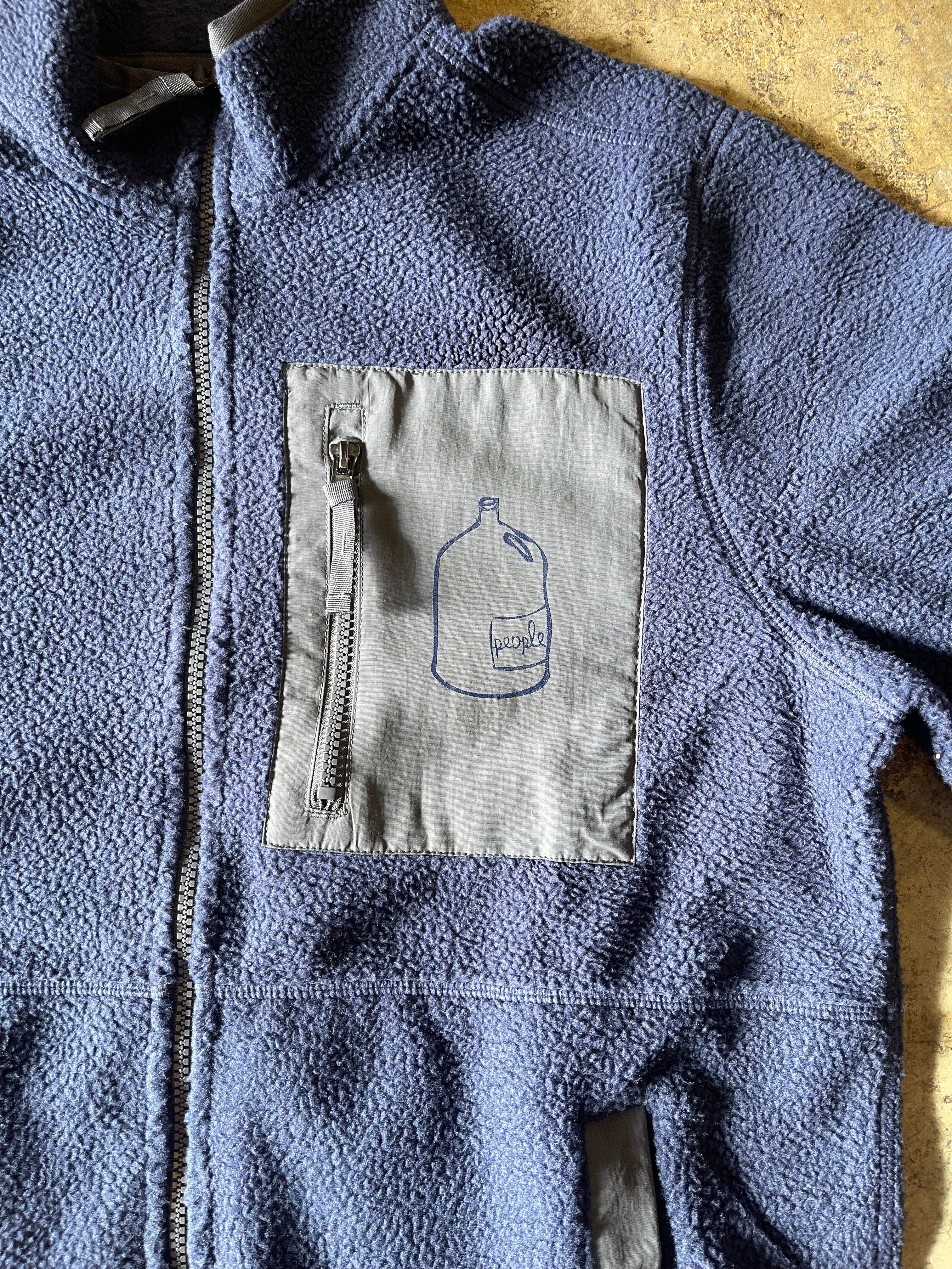 Blue fleece jacket with a patch on the chest