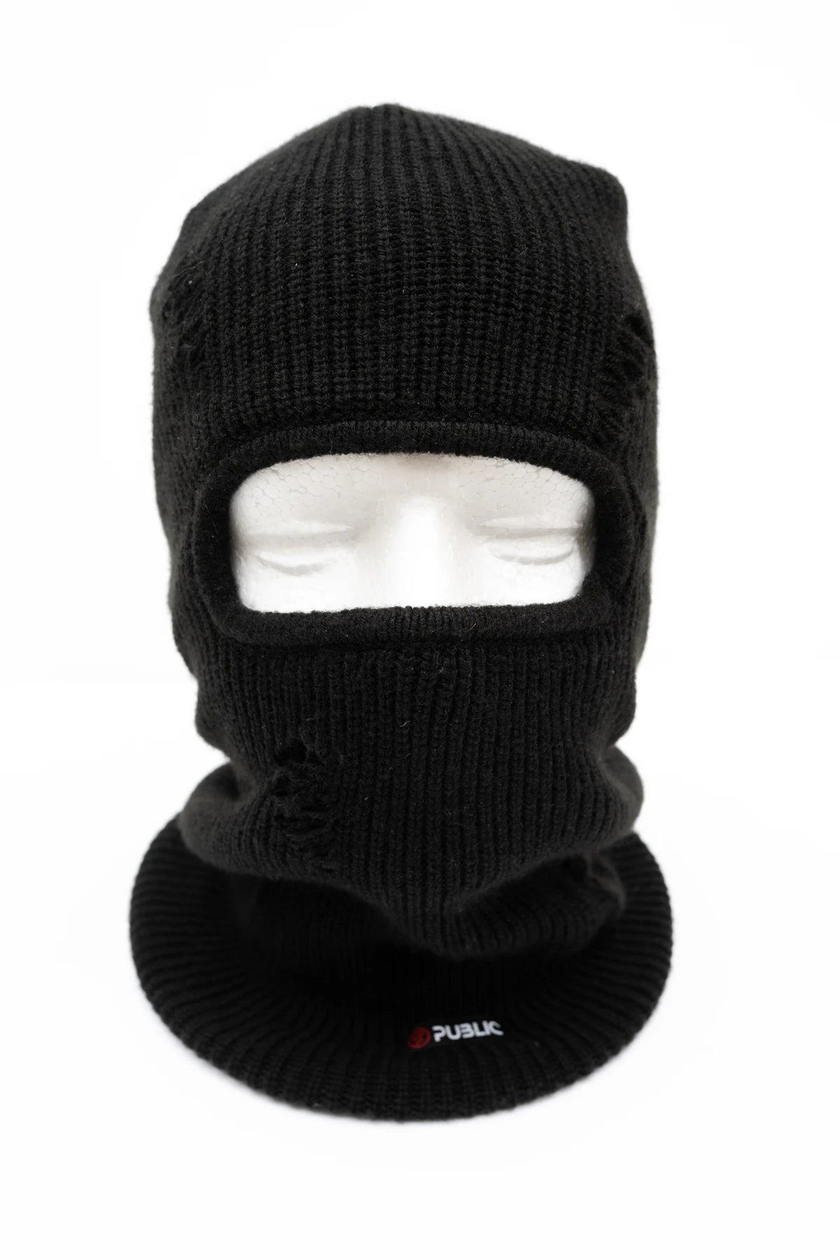 Public Snowboards distressed black balaclava worn on head, showcasing its face covering design for snowboarding and winter outdoor activities.