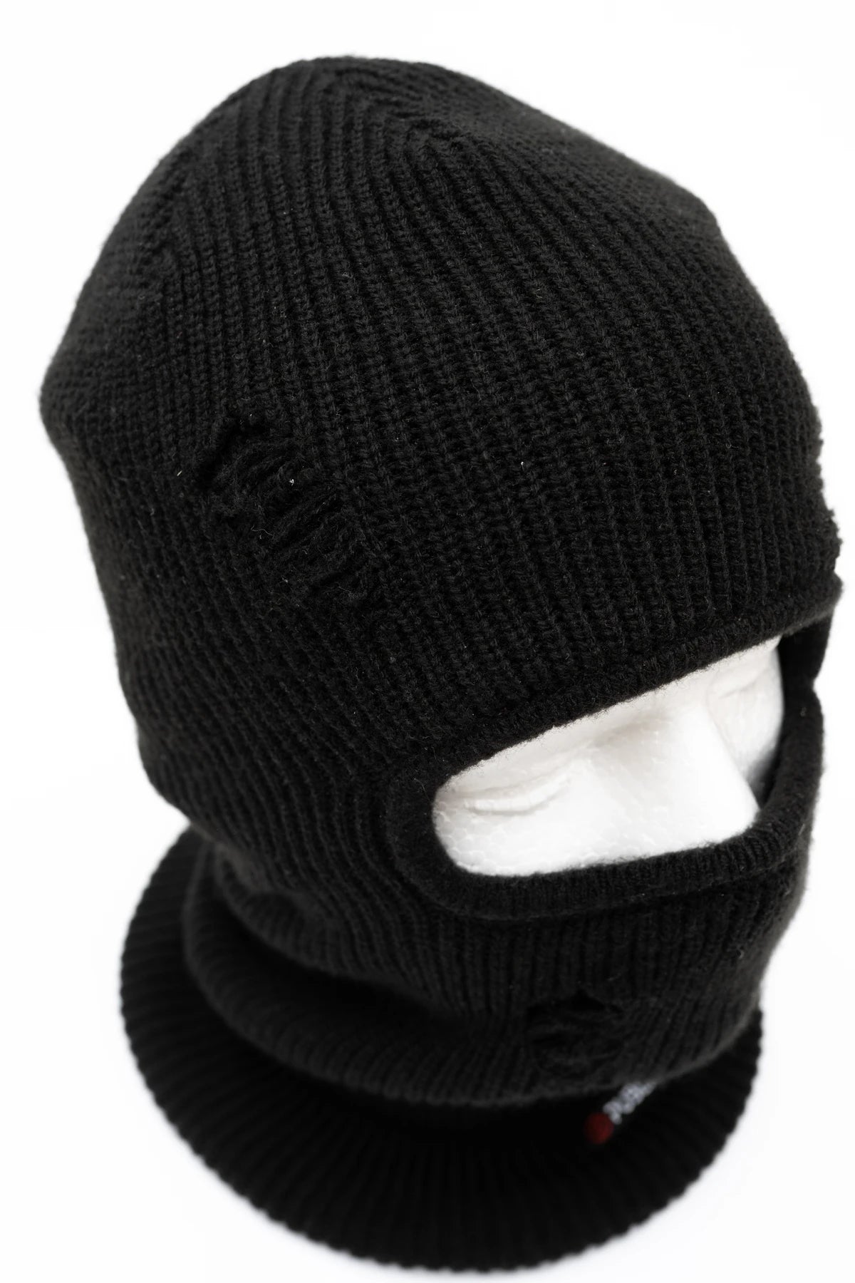 Public Snowboards distressed black balaclava worn on head, designed for snow face protection and winter outdoor activities.