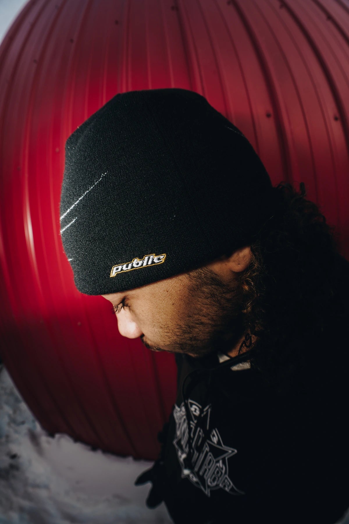 Black Public General Skully Beanie by Public Snowboards, stylish and warm accessory with logo side view.
