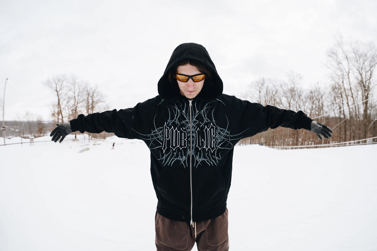 Black men's zip-up hoodie by Public Snowboards featuring a front view with a relaxed fit and casual style.