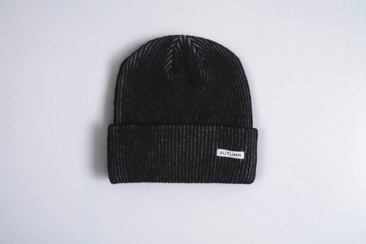 Black Autumn Cord Beanie by Autumn Headwear showing a cozy, stylish knit beanie in a close-up shot.