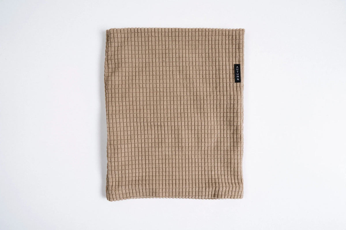 Autumn Headwear Autumn Grid Fleece Neck Gaiter in sand, a cozy face protection accessory for cold weather.