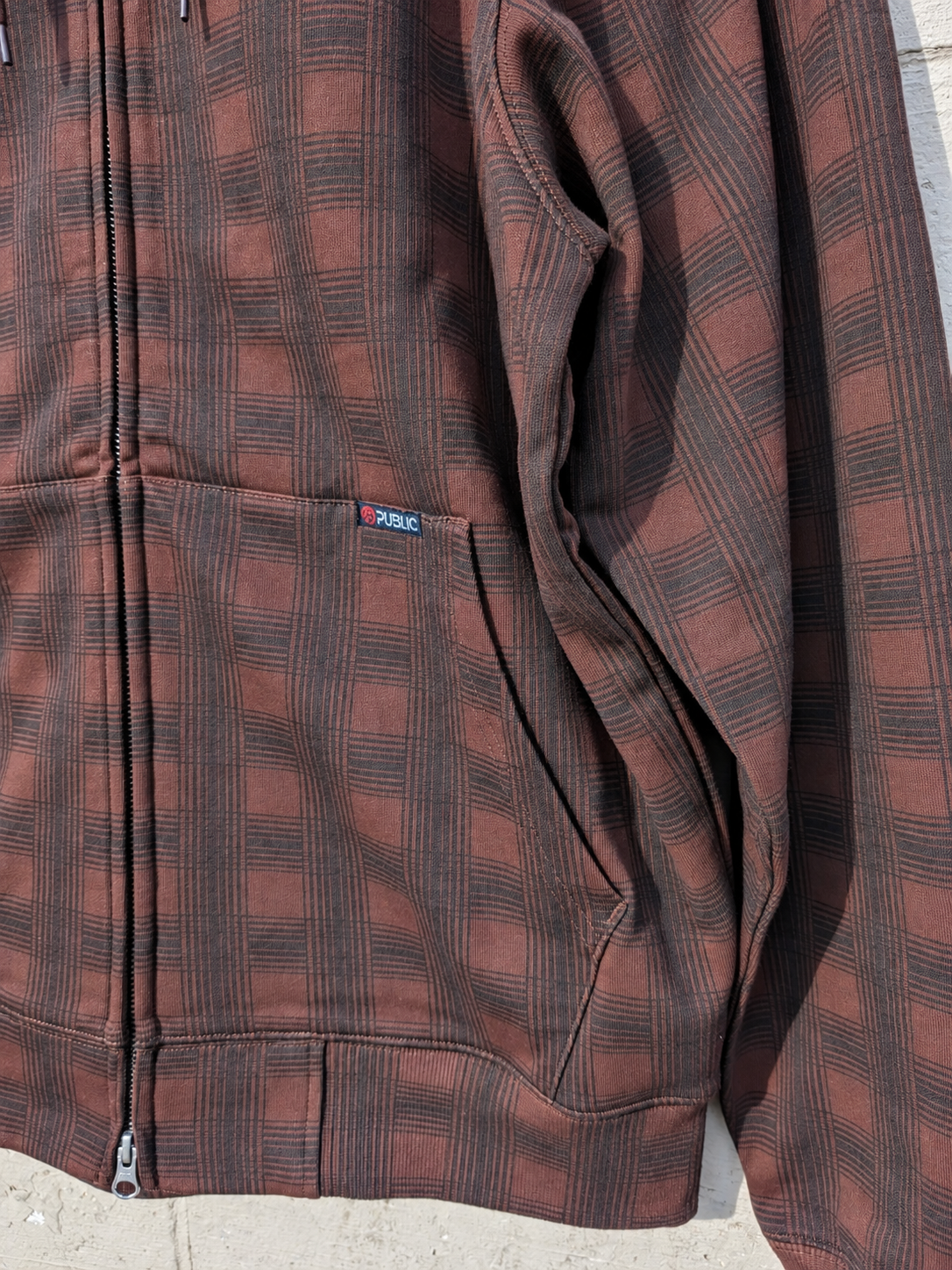 Public Snowboards men's brown plaid zip-up hoodie, casual sweatshirt with front pockets and adjustable hood, soft and comfortable.