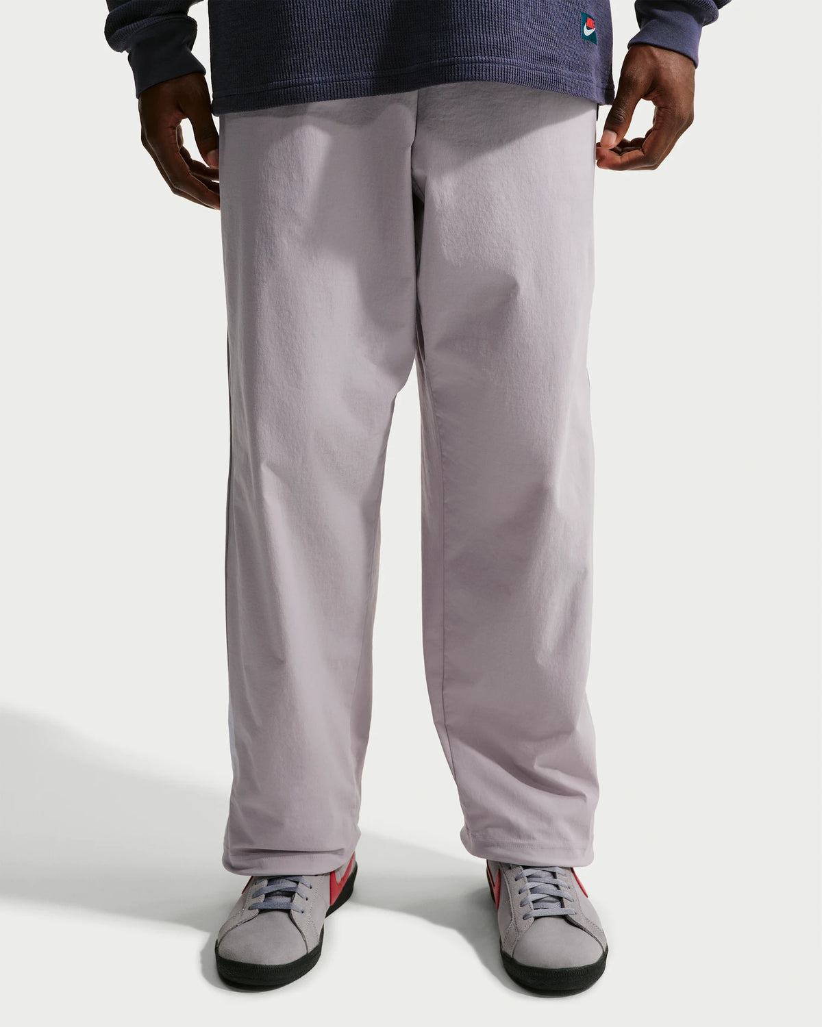 Nike SB men's woven skate pants in silver lilac and palest purple, front fit view