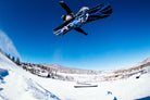Bataleon Placebo snowboard for men, lifestyle shot showing the snowboard's design and graphics on a snowy background.