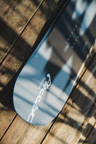 Men's Bataleon Placebo snowboard with a sleek design, shown in a lifestyle setting, ideal for all-mountain snowboarding.
