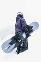 Bataleon Placebo snowboard for men, showcasing a lifestyle shot with the board's design and graphics on a snowy background.