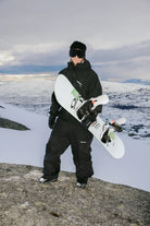 Bataleon Tornado x Beyond Medals men's snowboarding snowboard, lifestyle shot showcasing the board's design and graphics.