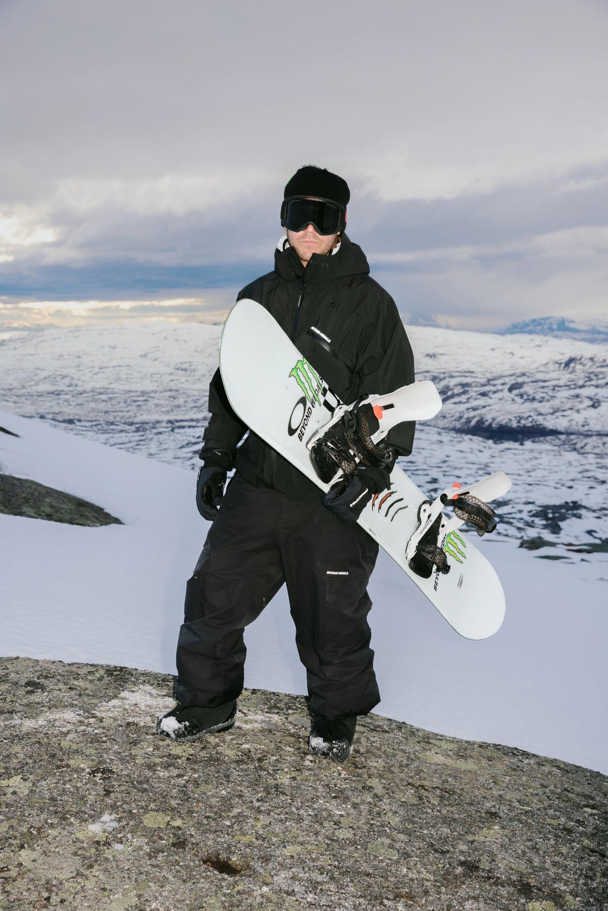 Bataleon Tornado x Beyond Medals men's snowboarding snowboard, lifestyle shot showcasing the board's design and graphics.