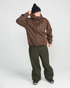 Volcom men's Lapper snow pants in dark green, side view with adjustable waist and reinforced cuffs