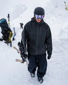 Volcom men's Top Stitch snow jacket in black denim worn on snow terrain