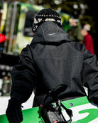 Volcom men's Top Stitch snow jacket in black denim, shown in a snowboard lifestyle setting