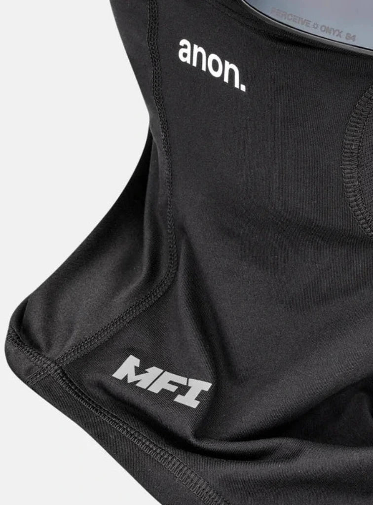Black ski mask neck gaiter with an integrated black ski/goggle strap, featuring the 'anon.' and 'MFI' logos, shown with a dark mirrored lens on a light gray background.
