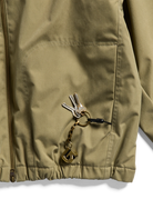 Beige Burton AG Dirtshift men's snow jacket with detailed hem, softgoods outdoor winter jacket for cold weather.