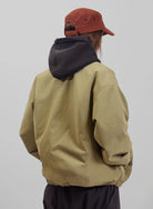 Back view of Burton AG Dirtshift Jacket for men, beige softshell snow jacket with Burton branding and functional design.