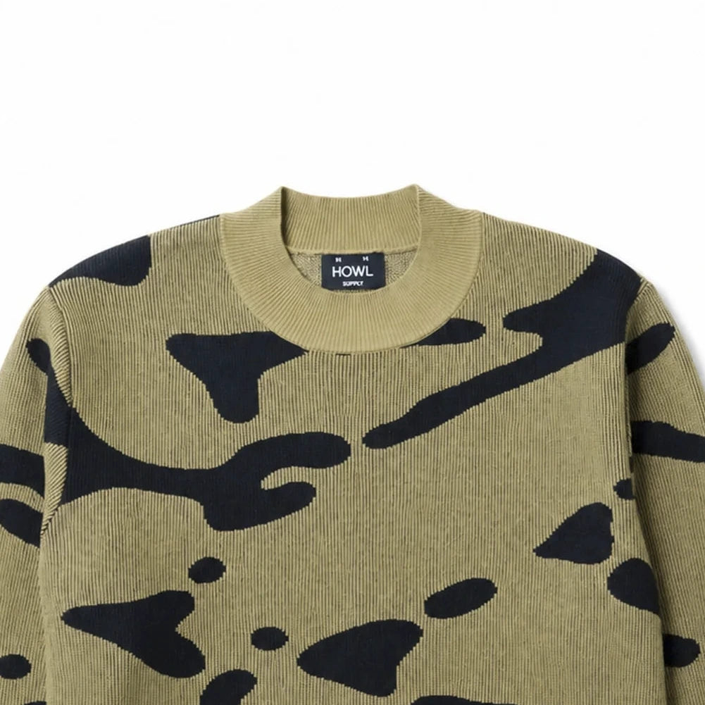 A crewneck knit sweater featuring a bold black abstract camouflage pattern on a khaki-beige base, displayed flat against a solid white background.