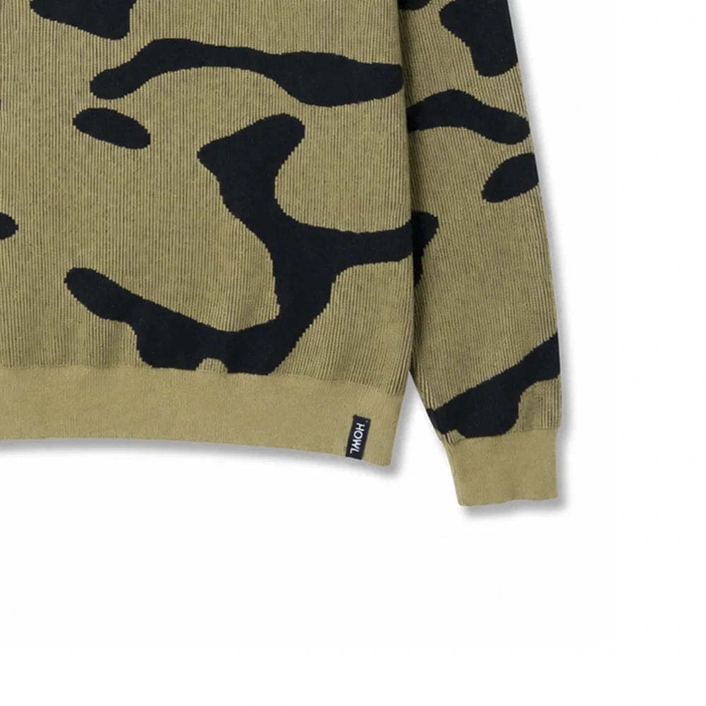 A crewneck knit sweater featuring a bold black abstract camouflage pattern on a khaki-beige base, displayed flat against a solid white background.