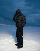 Black Howl Supply puffy snow jacket for men, featuring a padded design and winter warmth, suitable for cold weather outdoor activities.