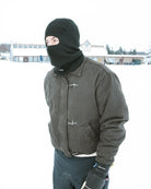 Public Snowboards distressed black balaclava worn as face protection for snowboarding and winter outdoor activities.