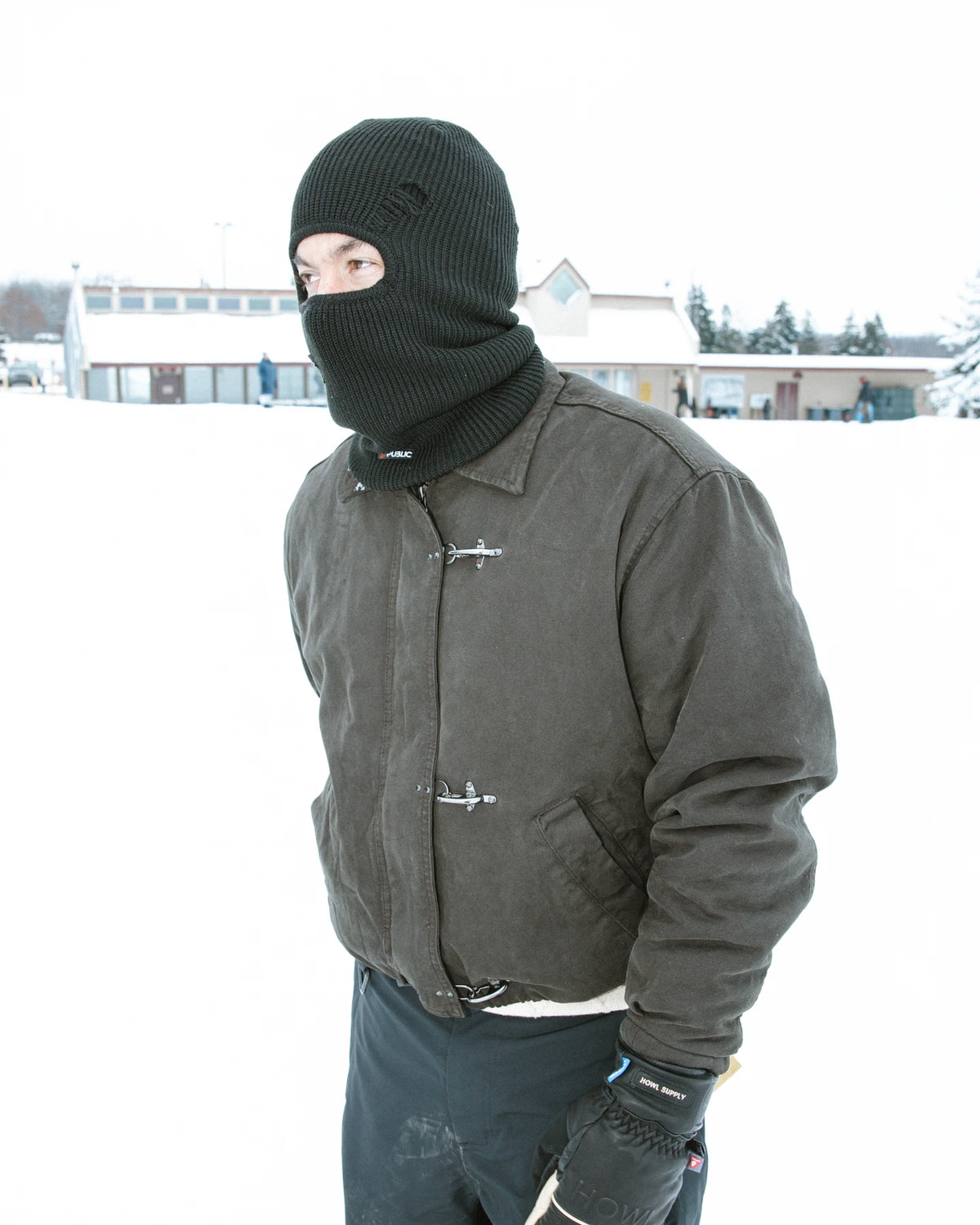 Public Snowboards distressed black balaclava worn as face protection for snowboarding and winter outdoor activities.