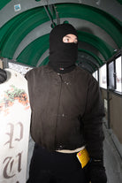 Public Snowboards distressed black balaclava worn as face protection in outdoor snowboarding scene