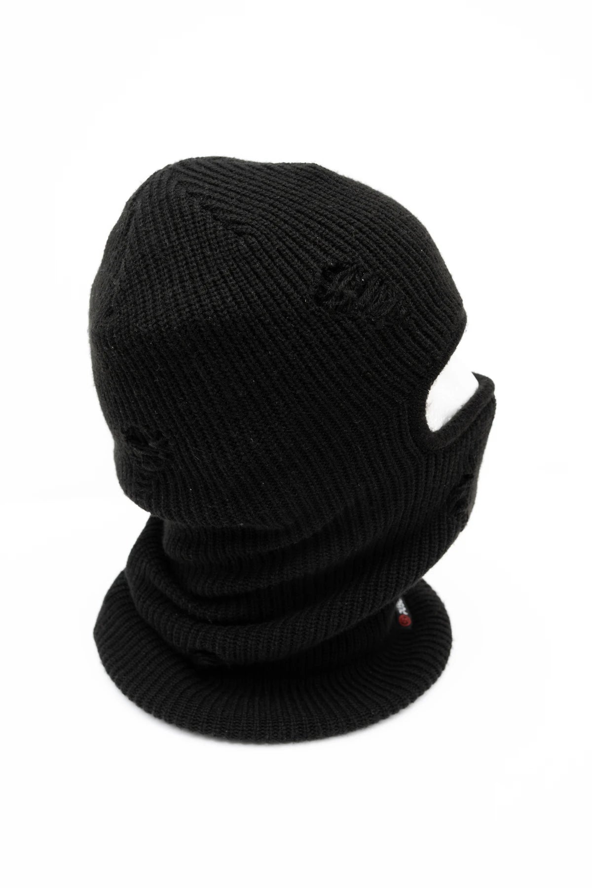 Public Snowboards distressed black balaclava worn on head, providing face protection for snowboarding and winter outdoor activities.