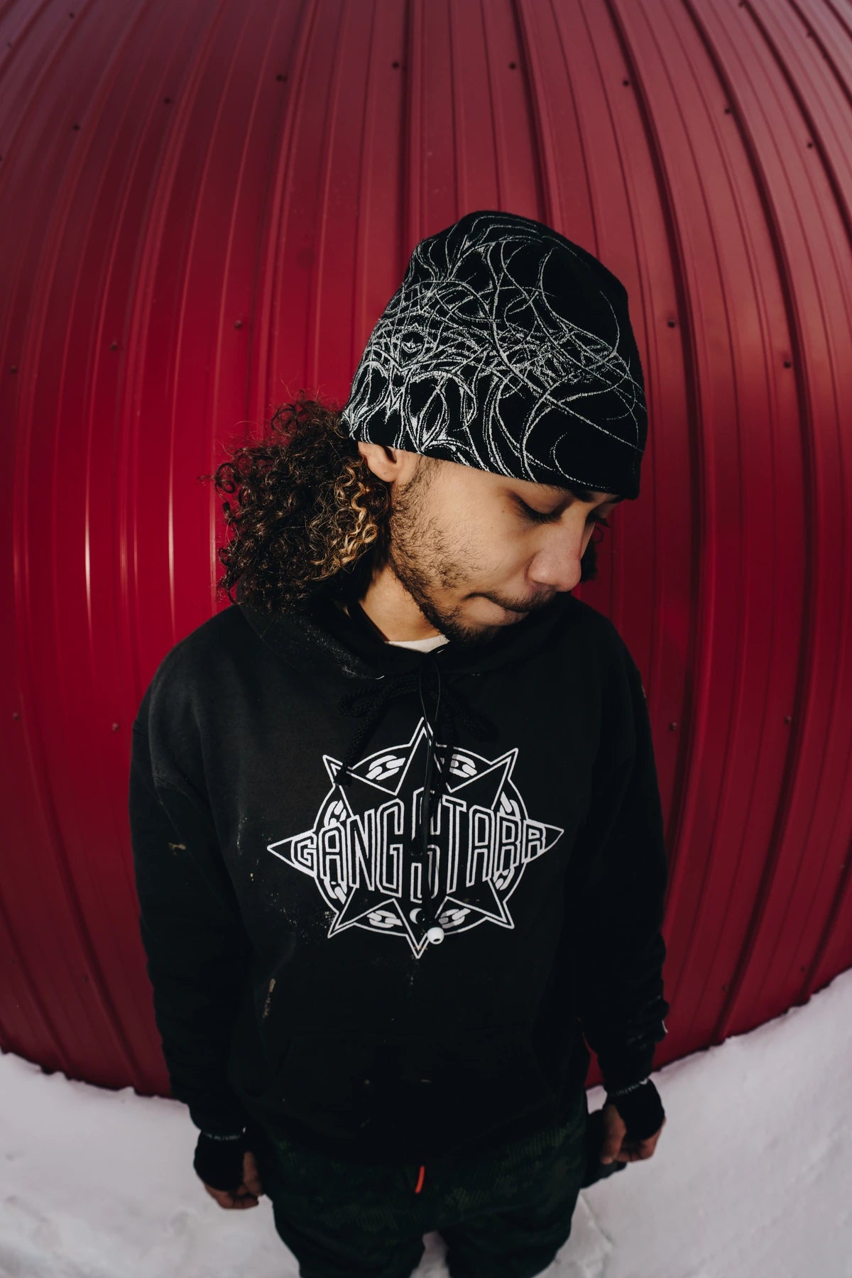 Public Snowboards black Skully Beanie, a cozy accessory with a folded brim, shown in a lifestyle angle.