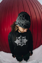 Black Public General Skully Beanie from Public Snowboards, featuring a snug fit and casual style, shown in a lifestyle setting.