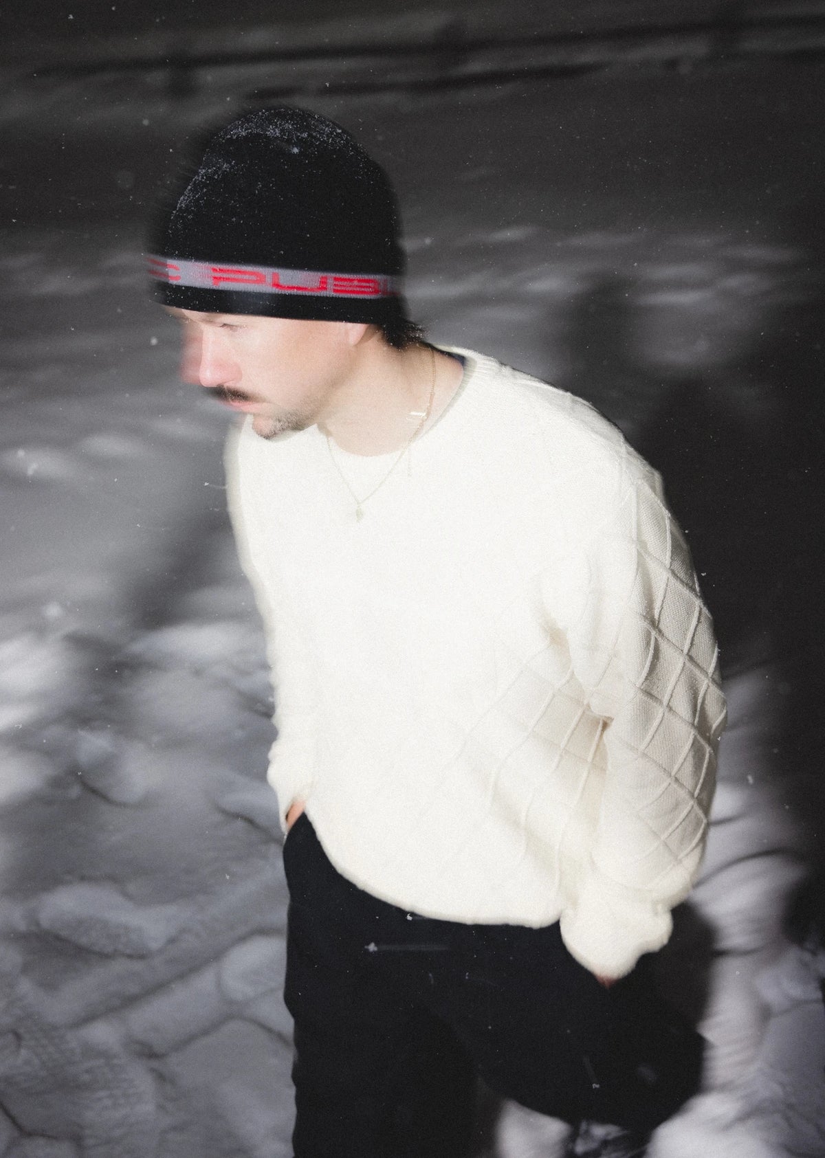 Public Snowboards black and red Stretch Logo Skully Beanie worn as a stylish winter accessory with a snug fit.