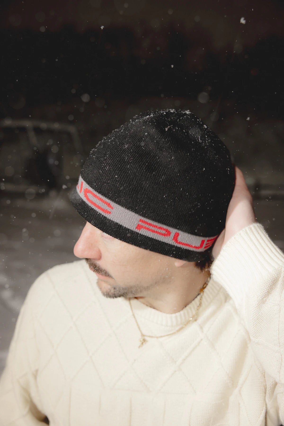 Public Snowboards black and red stretch logo skully beanie worn as a stylish winter accessory.