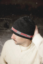 Public Snowboards black and red stretch logo skully beanie worn as a stylish winter accessory.