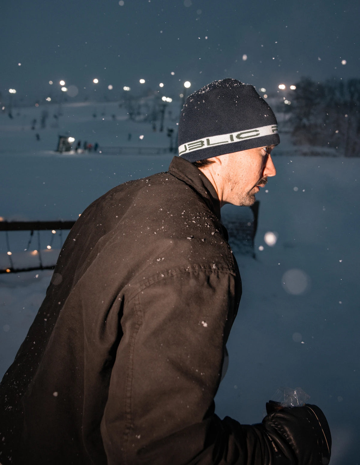 Public Snowboards navy stretch logo skully beanie with white branding, styled for casual winter wear.