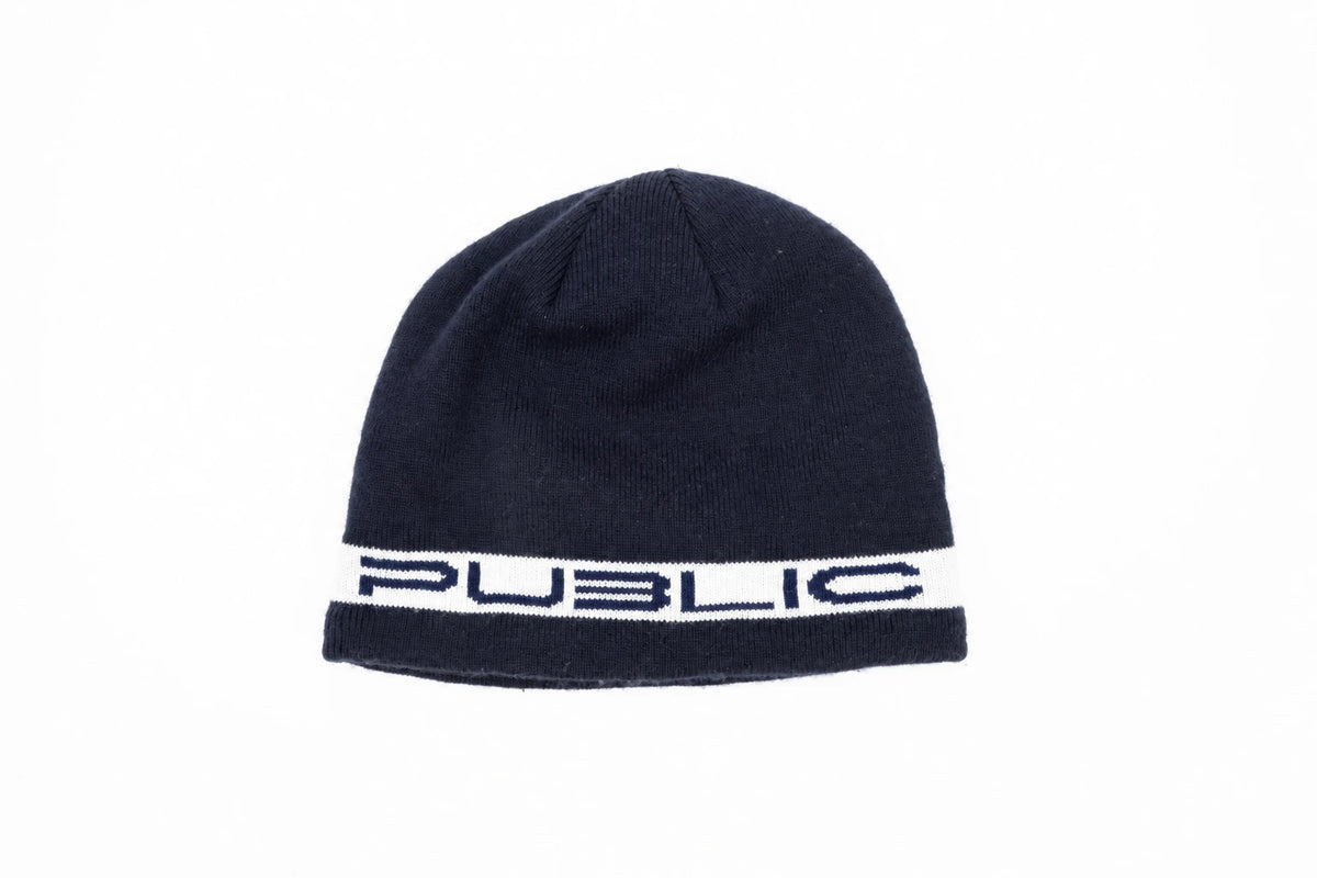 Navy Public Snowboards Stretch Logo Skully Beanie with white logo detail, cozy knit accessory for winter warmth.