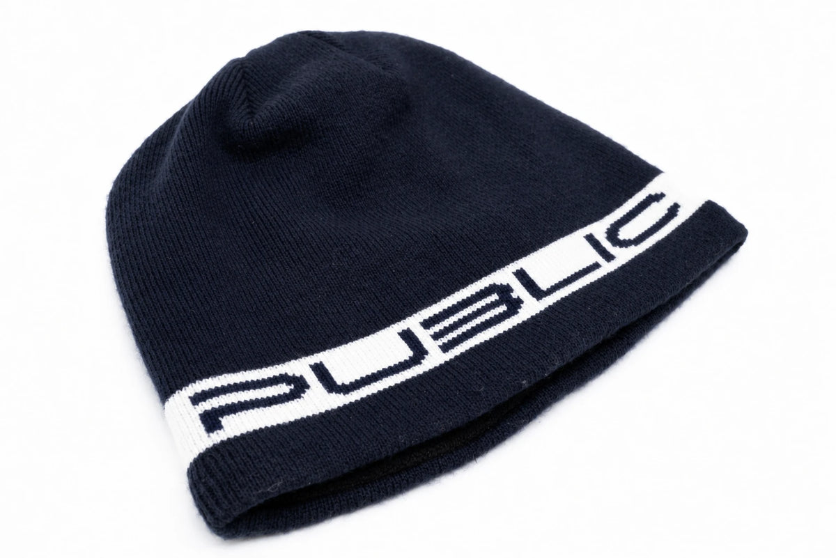 Public Snowboards navy stretch logo skully beanie with white logo, made from soft, stretchy fabric, front view.