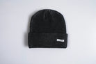 Black Autumn Cord Beanie by Autumn Headwear showing a cozy, stylish knit beanie in a close-up shot.
