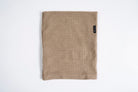 Autumn Headwear Autumn Grid Fleece Neck Gaiter in sand, a cozy face protection accessory for cold weather.