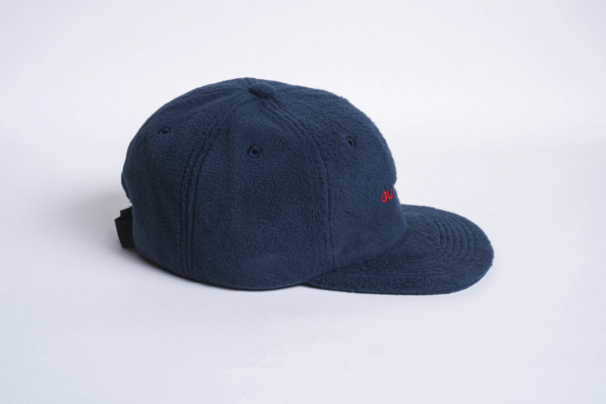Autumn Headwear midnight six-panel fleece cap, stylish and warm accessory, shown from side view with stitched panels and curved brim.