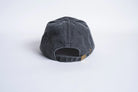 Black six-panel strapback hat from Autumn Headwear with adjustable strap and classic design.