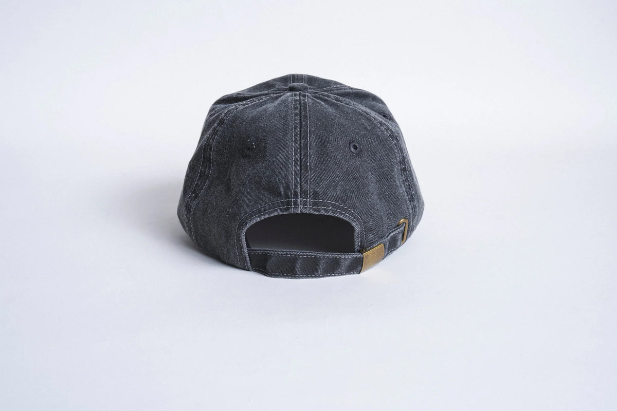 Black six-panel strapback hat from Autumn Headwear with adjustable strap and classic design.