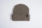 Autumn Stripe Beanie by Autumn Headwear featuring a cozy knit design with orange, white, and brown stripes, perfect for fall weather.