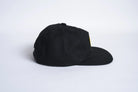 Black Autumn Twill Five Panel Snapback hat by Autumn Headwear, showing front and side view of the stylish accessory.
