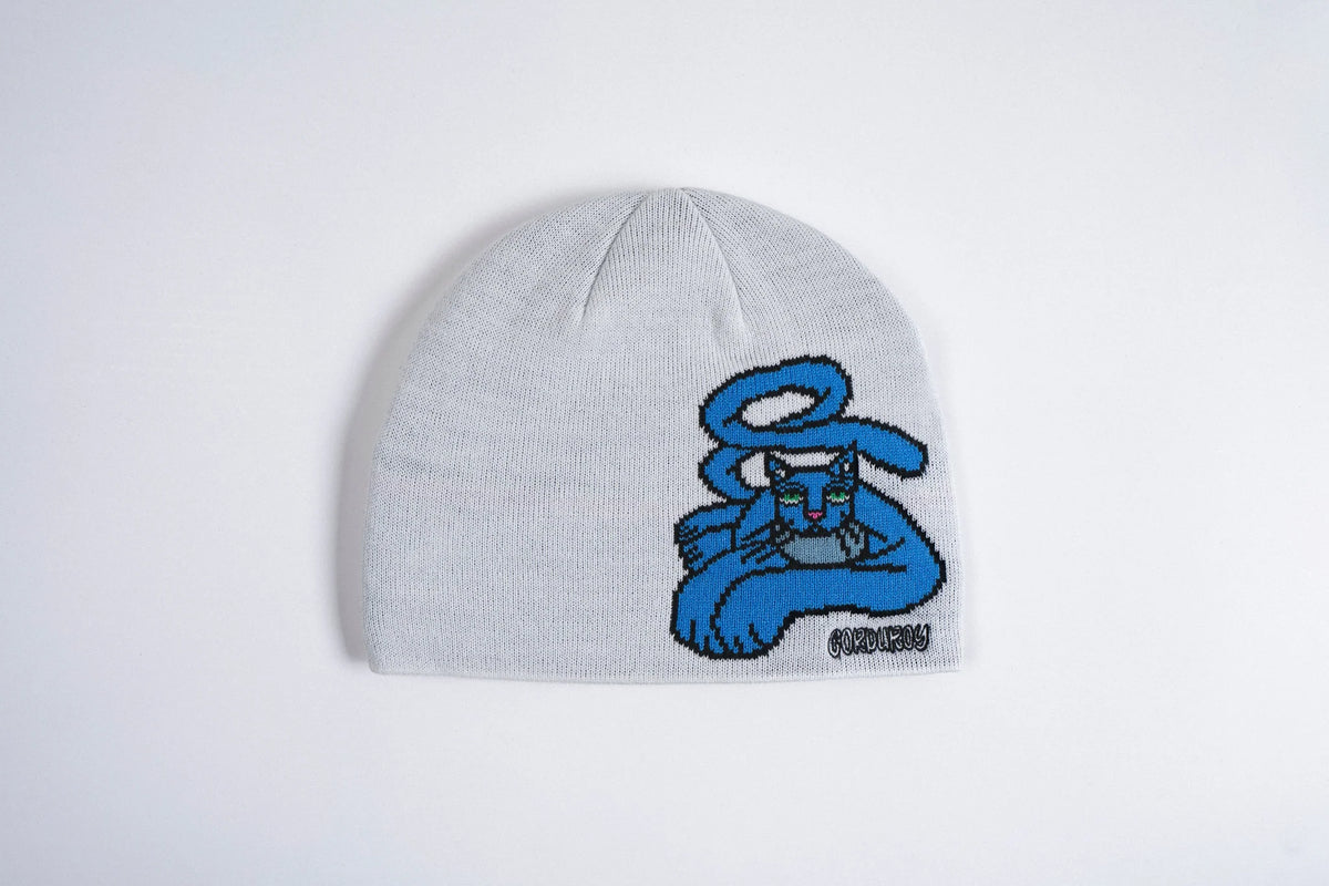White corduroy beanie featuring a blue cat design from Jamie Lynn Beanie, stylish accessory for casual wear.
