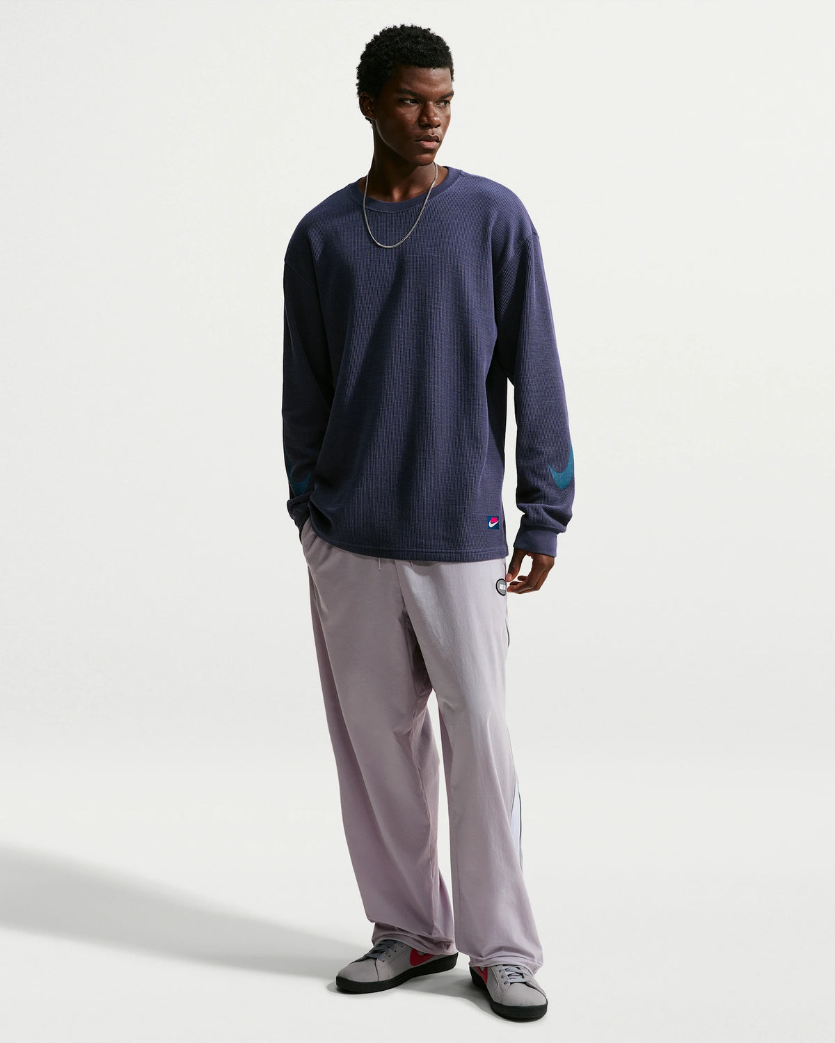 Nike SB men's woven skate pants in Silver Lilac and Palest Purple, front view on model