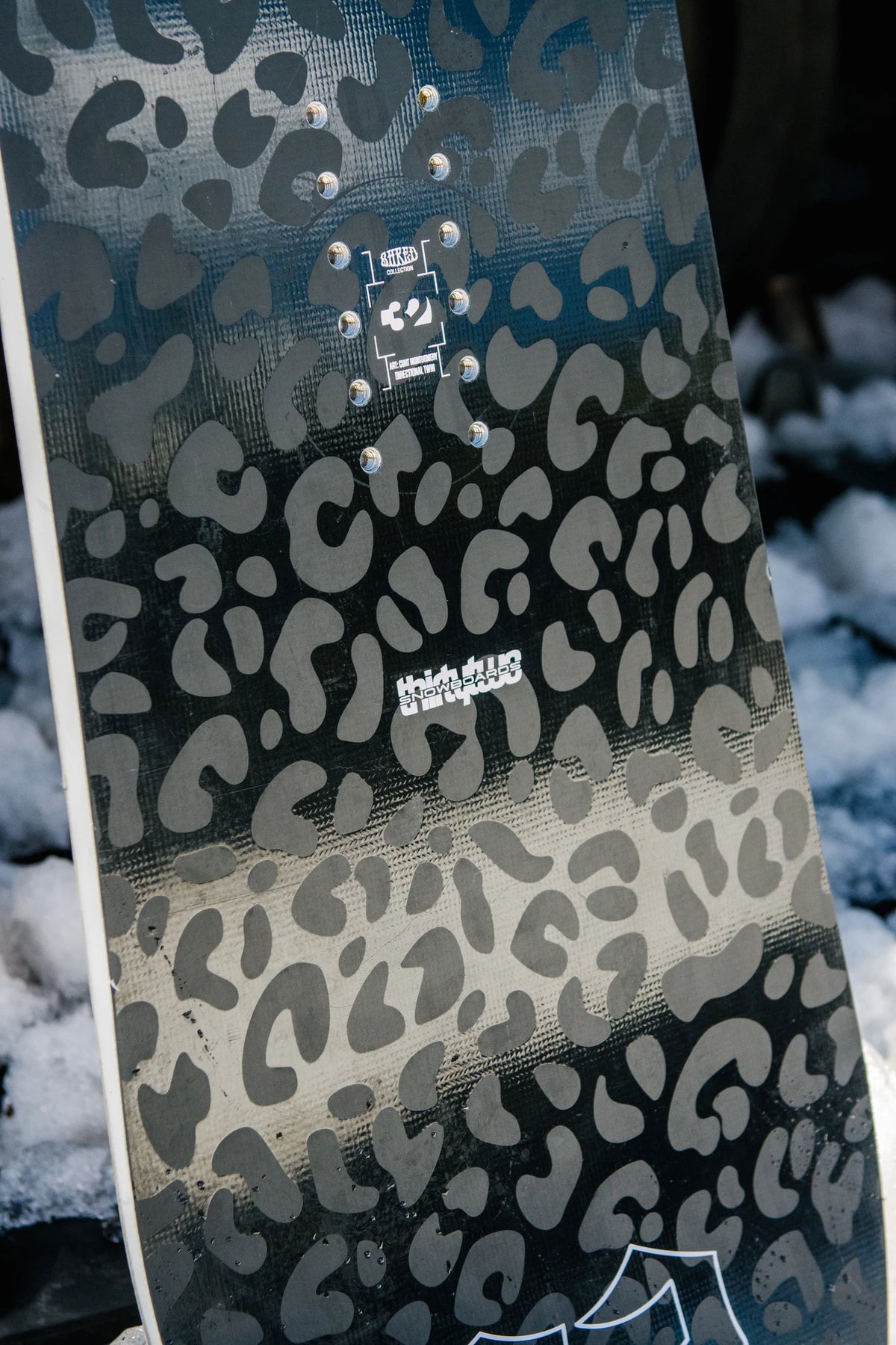ThirtyTwo Women’s Crucible snowboard lifestyle image showing the board’s design and graphics